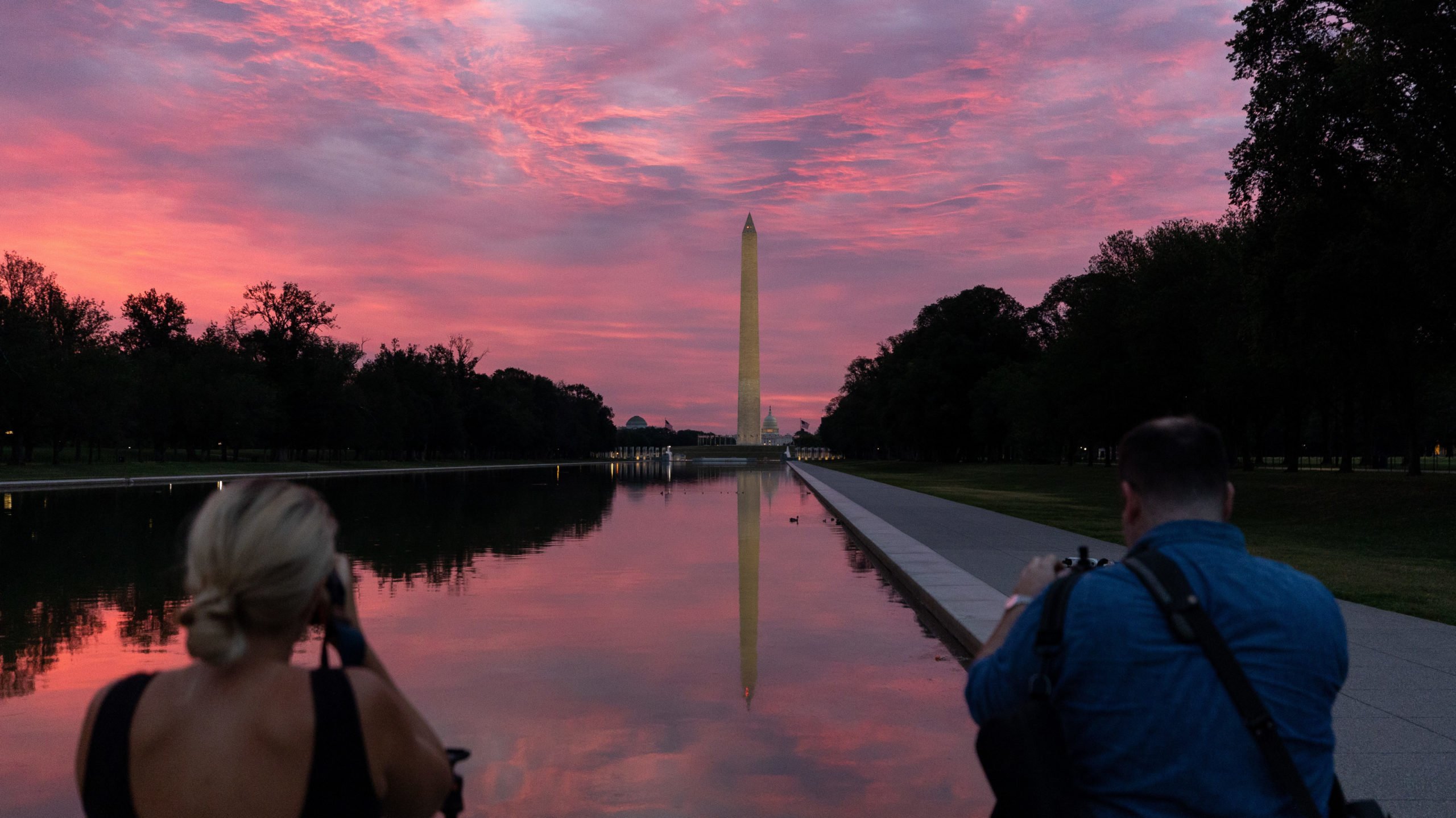 Photographers at the Reflecting Pool in Washington DC during sunrise